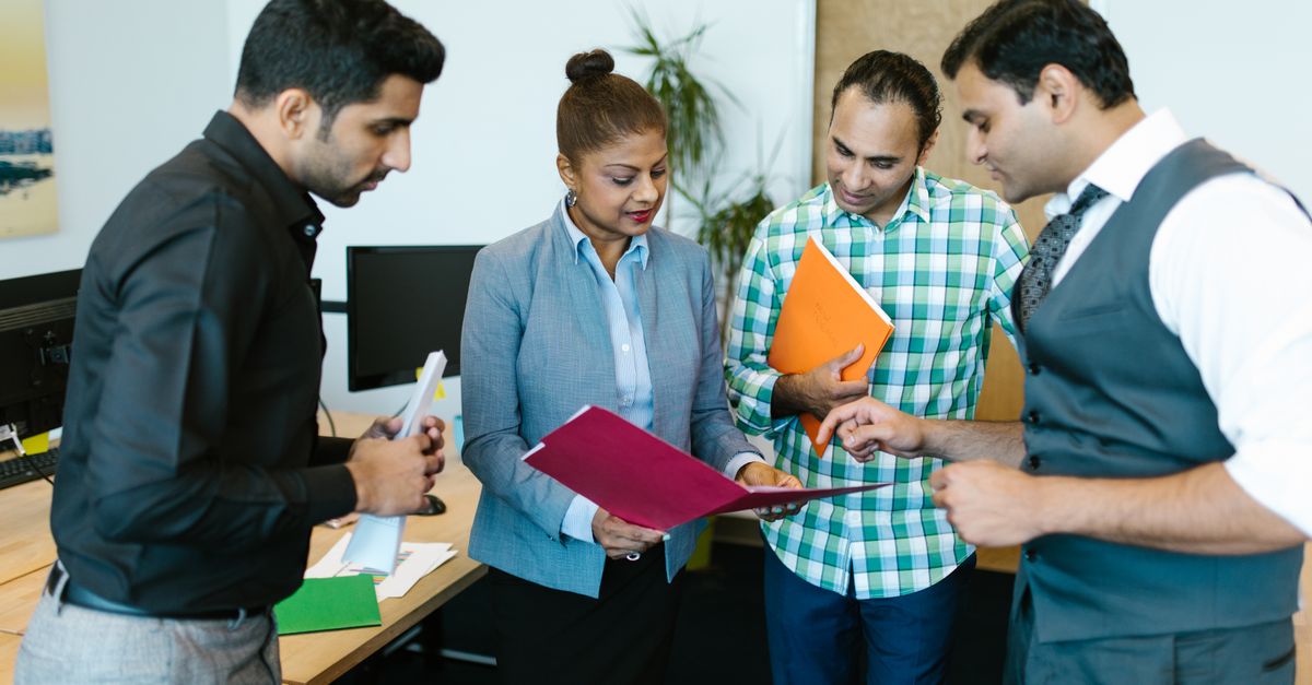 Business team engaged in discussion during a meeting in a modern office setting.